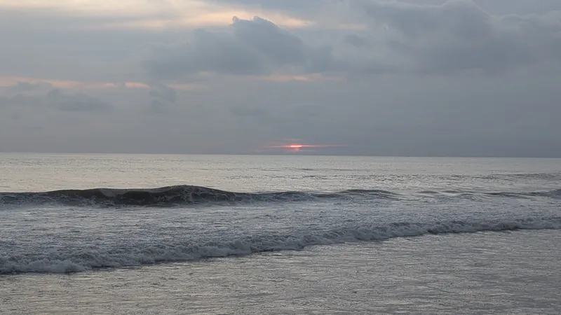 Low cloud band sitting on the ocean horizon at sunset
