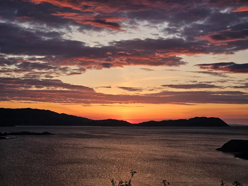 Dramatic pink and orange sky over ocean islands